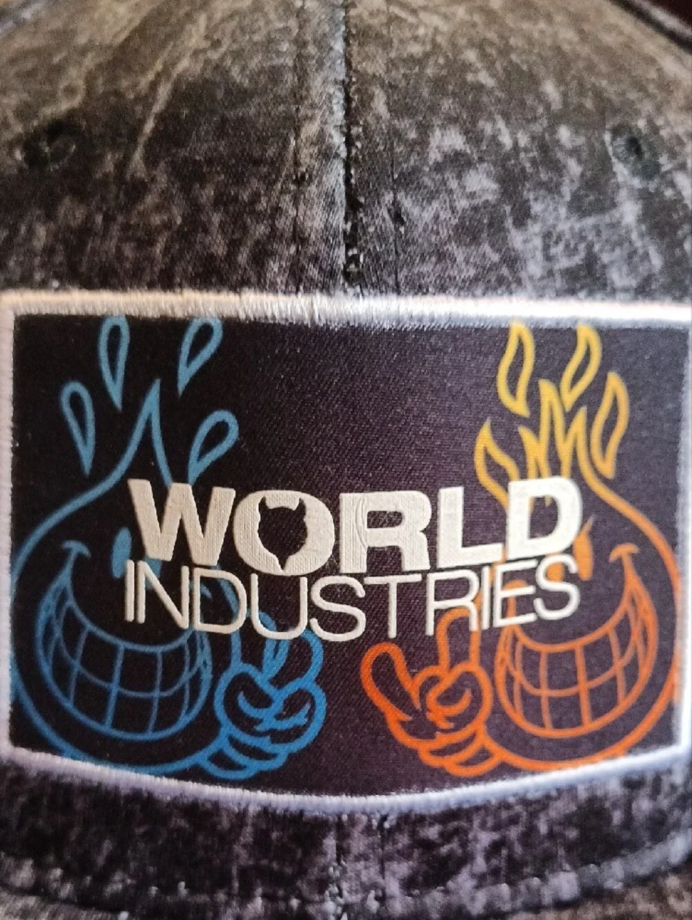 World Industries black acid wash snapback hat featuring an embroidered patch